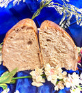 Sliced loaf of bread on a blue fabric background with flowers