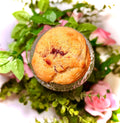cookie on a glass jar with greenery and flowers on a white background