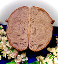 Sliced loaf of bread on a blue fabric with decorative flowers